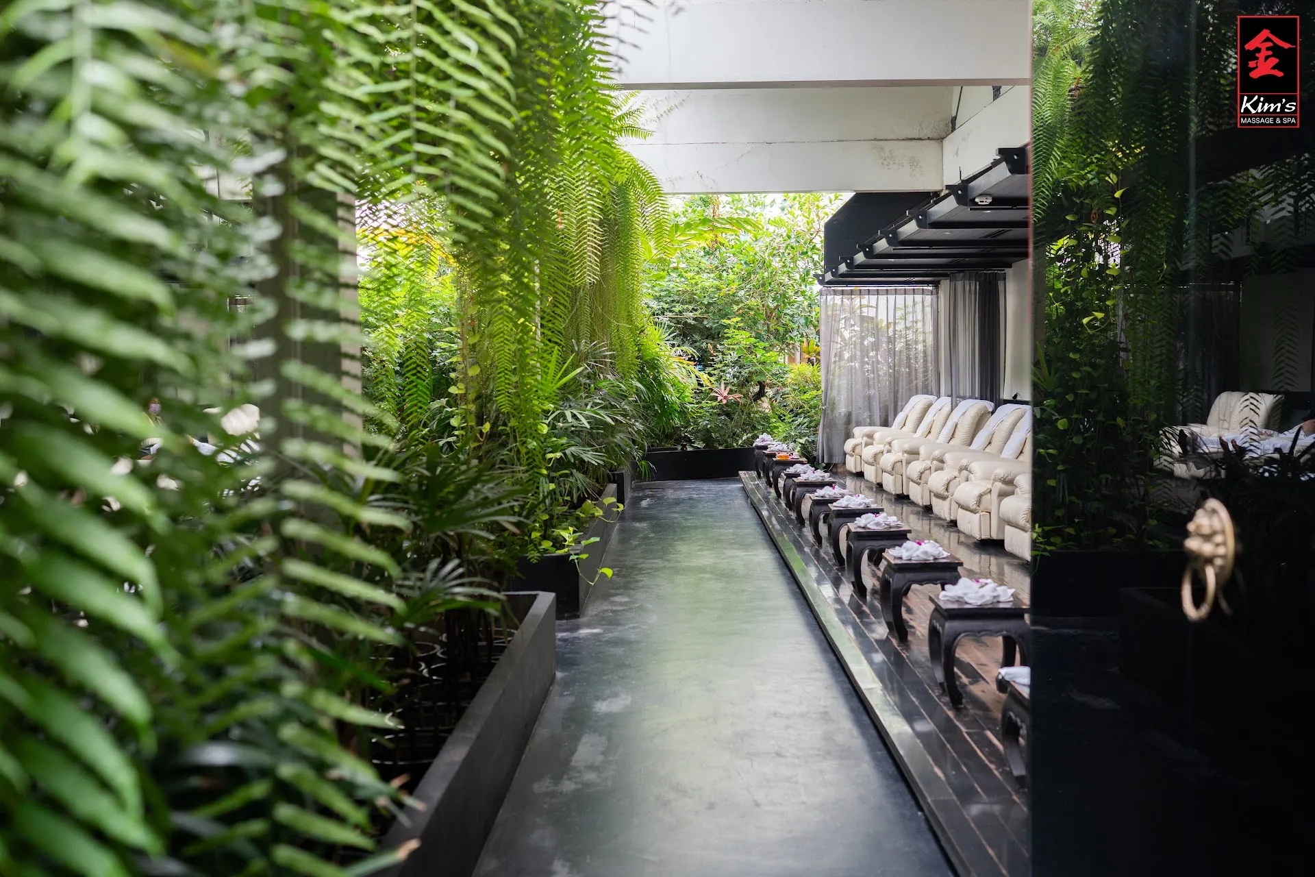 Foot massage lounge beside a green garden