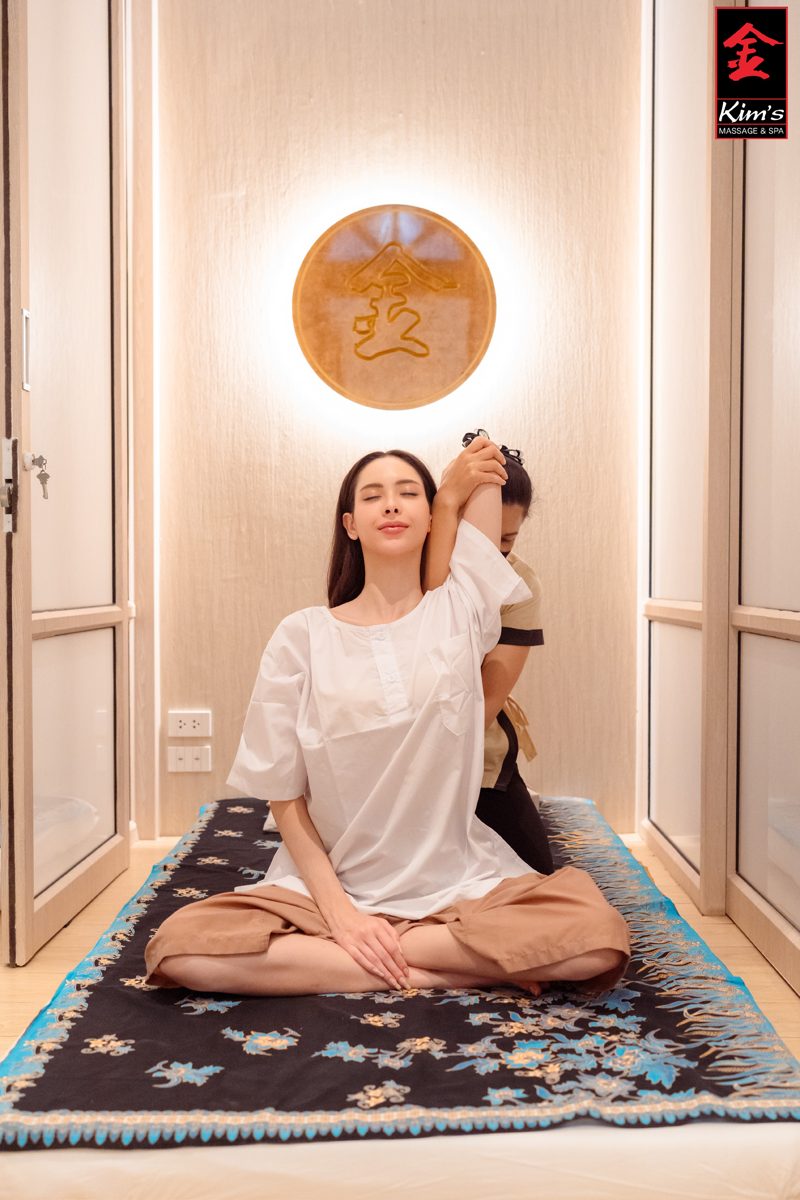 Therapist performing a traditional Thai stretch